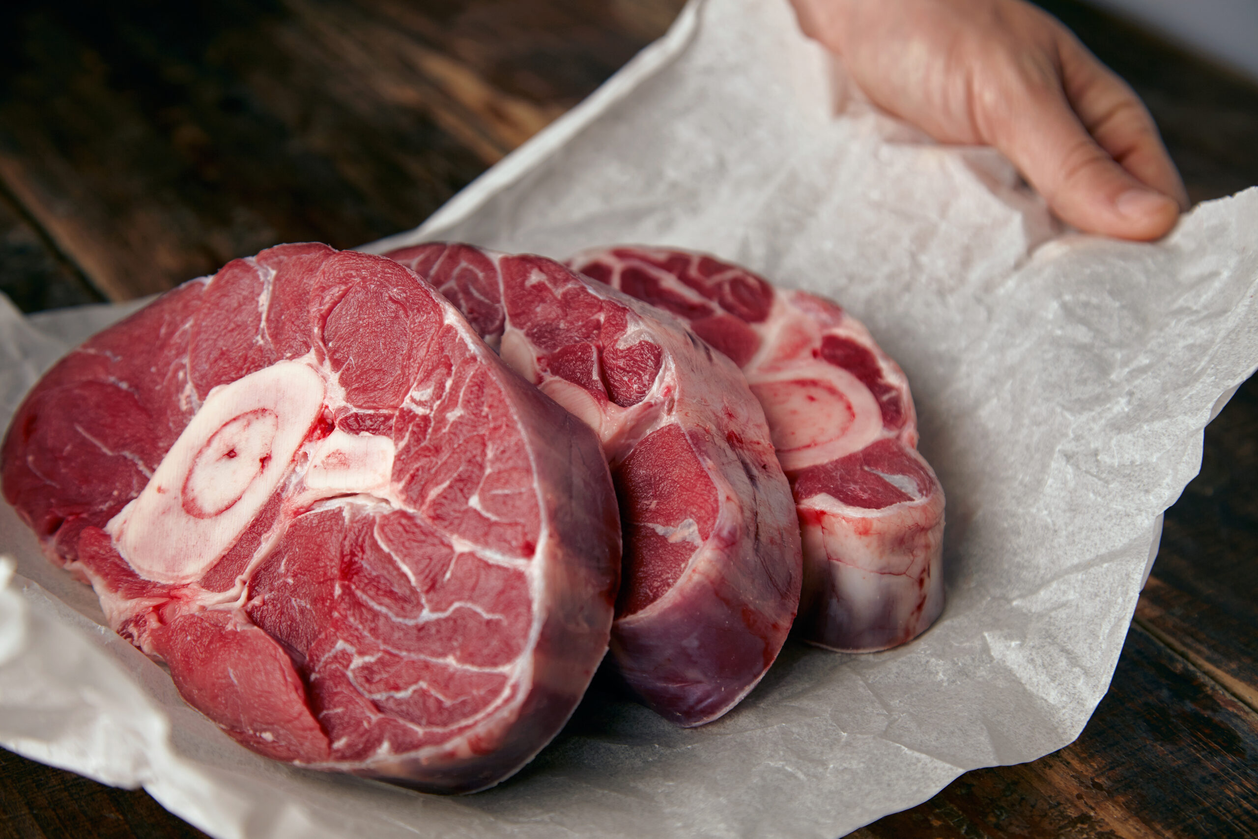 Closeup of three cosher meat steaks with bone for dinner